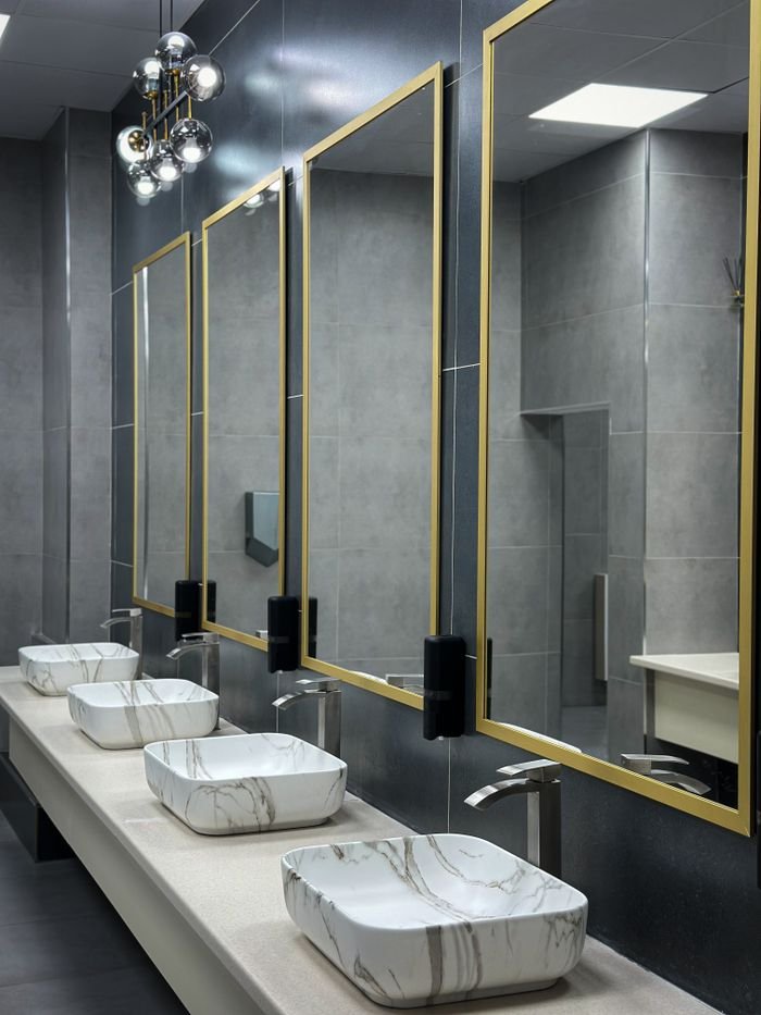 Sleek bathroom interior featuring marble sinks and stylish mirrors.